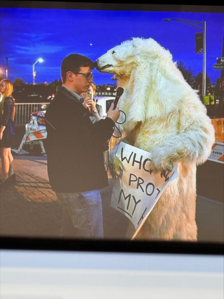 One of the journalist and them interviewing a mascot.